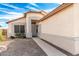 Inviting beige home featuring a decorative front door, a garden bed and a concrete walkway at 8553 N 112Th Ave, Peoria, AZ 85345