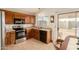 Well-lit kitchen features stainless steel appliances and wood cabinetry at 8553 N 112Th Ave, Peoria, AZ 85345