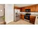 Well-lit kitchen features stainless steel appliances and wood cabinetry at 8553 N 112Th Ave, Peoria, AZ 85345