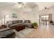 Cozy living room with tile floors, ceiling fan, and gray sectional sofa at 8553 N 112Th Ave, Peoria, AZ 85345