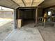 Unfinished garage interior with exposed floor and storage items at 9428 N 9Th Ave, Phoenix, AZ 85021