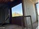 View from inside a shipping container home, looking out towards a hilltop house at 9428 N 9Th Ave, Phoenix, AZ 85021