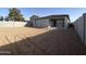 Large yard with block wall and covered back patio at 9526 W Luxton Ln, Tolleson, AZ 85353