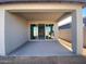 Covered patio with sliding glass doors leading to the home at 9526 W Luxton Ln, Tolleson, AZ 85353