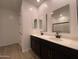 Bathroom with double sinks, black fixtures, white countertops, and framed mirrors at 9526 W Luxton Ln, Tolleson, AZ 85353