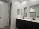 Bright bathroom with dual vanities, modern fixtures, and ample counter space at 9526 W Luxton Ln, Tolleson, AZ 85353