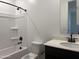 This bathroom features a shower-tub combo with black fixtures and a modern vanity at 9526 W Luxton Ln, Tolleson, AZ 85353