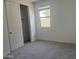 Cozy bedroom featuring closet, soft carpeting, and a window at 9526 W Luxton Ln, Tolleson, AZ 85353