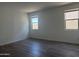 Bedroom featuring wood-look tile flooring and large windows at 9526 W Luxton Ln, Tolleson, AZ 85353