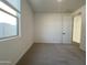 Carpeted bedroom with bright window and a neutral color scheme at 9526 W Luxton Ln, Tolleson, AZ 85353