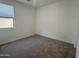 Well-lit carpeted bedroom with window and ample wall space at 9526 W Luxton Ln, Tolleson, AZ 85353