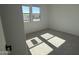 Bright bedroom with neutral carpet and abundant natural light from two windows at 9526 W Luxton Ln, Tolleson, AZ 85353