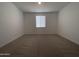 Bright, carpeted bedroom featuring a window with blinds at 9526 W Luxton Ln, Tolleson, AZ 85353