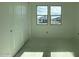 Well-lit bedroom featuring a double-door closet and windows at 9526 W Luxton Ln, Tolleson, AZ 85353