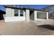 Newly built home with light gray exterior and a two-car garage at 9526 W Luxton Ln, Tolleson, AZ 85353