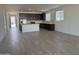 Open-concept kitchen with dark cabinetry, stainless steel appliances, and a center island at 9526 W Luxton Ln, Tolleson, AZ 85353