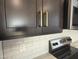 Close up of kitchen featuring granite countertops, subway tile backsplash, and gold hardware at 9526 W Luxton Ln, Tolleson, AZ 85353