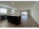 Open-concept kitchen featuring a large island and wood-look tile flooring at 9526 W Luxton Ln, Tolleson, AZ 85353