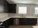 Modern kitchen featuring dark cabinetry, stainless steel appliances, and bright countertops and subway tile backsplash at 9526 W Luxton Ln, Tolleson, AZ 85353