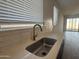 Kitchen sink with stainless steel faucet and natural light at 9526 W Luxton Ln, Tolleson, AZ 85353