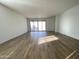 Bright living room with sliding glass doors leading to the backyard at 9526 W Luxton Ln, Tolleson, AZ 85353