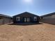 New construction backyard offering an open space for personalization, with a house featuring a grey exterior at 9530 W Luxton Ln, Tolleson, AZ 85353