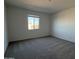 Bright bedroom featuring neutral walls, carpeted floors, and a window offering natural light at 9530 W Luxton Ln, Tolleson, AZ 85353