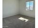 Cozy bedroom with neutral carpet and a bright window at 9530 W Luxton Ln, Tolleson, AZ 85353