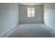 Bright and airy bedroom with large window and neutral walls at 9530 W Luxton Ln, Tolleson, AZ 85353