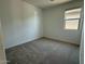 Comfortable bedroom with neutral carpeting and a large window at 9530 W Luxton Ln, Tolleson, AZ 85353