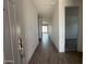 Inviting hallway with wood-style floors leading to the living spaces at 9530 W Luxton Ln, Tolleson, AZ 85353