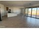 Open-concept kitchen featuring white cabinets, an island, and stainless steel appliances, great for cooking and entertaining at 9530 W Luxton Ln, Tolleson, AZ 85353