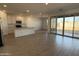 Spacious living room with lots of natural light, flowing seamlessly into an open-concept kitchen at 9530 W Luxton Ln, Tolleson, AZ 85353