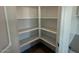 Spacious walk-in pantry with ample shelving for organized storage at 9530 W Luxton Ln, Tolleson, AZ 85353