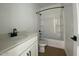 Clean bathroom with white bathtub, sink, and black accents at 9534 W Luxton Ln, Tolleson, AZ 85353