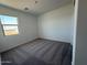 Bright bedroom with soft carpeting and a large window offering natural light at 9534 W Luxton Ln, Tolleson, AZ 85353