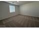 Bright bedroom features neutral carpet, a window with blinds, and neutral color scheme at 9534 W Luxton Ln, Tolleson, AZ 85353