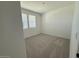 Cozy bedroom with plush carpeting and bright natural light from the double window at 9534 W Luxton Ln, Tolleson, AZ 85353