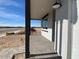 Covered front porch with brick flooring and black support beams at 9534 W Luxton Ln, Tolleson, AZ 85353