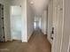 Bright hallway with light walls and wood-look flooring at 9534 W Luxton Ln, Tolleson, AZ 85353