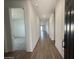 Inviting hallway with wood-look tile flooring leads into the home's main living areas at 9534 W Luxton Ln, Tolleson, AZ 85353