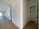 A bright hallway with access to a closet and other rooms at 9534 W Luxton Ln, Tolleson, AZ 85353