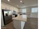 Modern kitchen featuring white cabinets, stainless steel appliances, and a large island at 9534 W Luxton Ln, Tolleson, AZ 85353