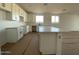 Modern kitchen featuring white cabinets and a large island at 9534 W Luxton Ln, Tolleson, AZ 85353