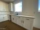 White kitchen cabinets and a clean sink area at 9534 W Luxton Ln, Tolleson, AZ 85353