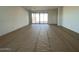 Spacious living room with sliding glass doors leading to the backyard at 9534 W Luxton Ln, Tolleson, AZ 85353