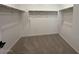 Spacious walk-in closet featuring carpet and plenty of shelving and storage space at 9534 W Luxton Ln, Tolleson, AZ 85353