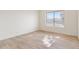 Well-lit bedroom with wood-look tile flooring and window blinds at 9832 W Oraibi Dr, Peoria, AZ 85382