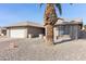 House exterior with rock landscaping and palm trees at 9832 W Oraibi Dr, Peoria, AZ 85382