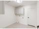 Laundry room with upper cabinets and patterned tile floor at 9832 W Oraibi Dr, Peoria, AZ 85382